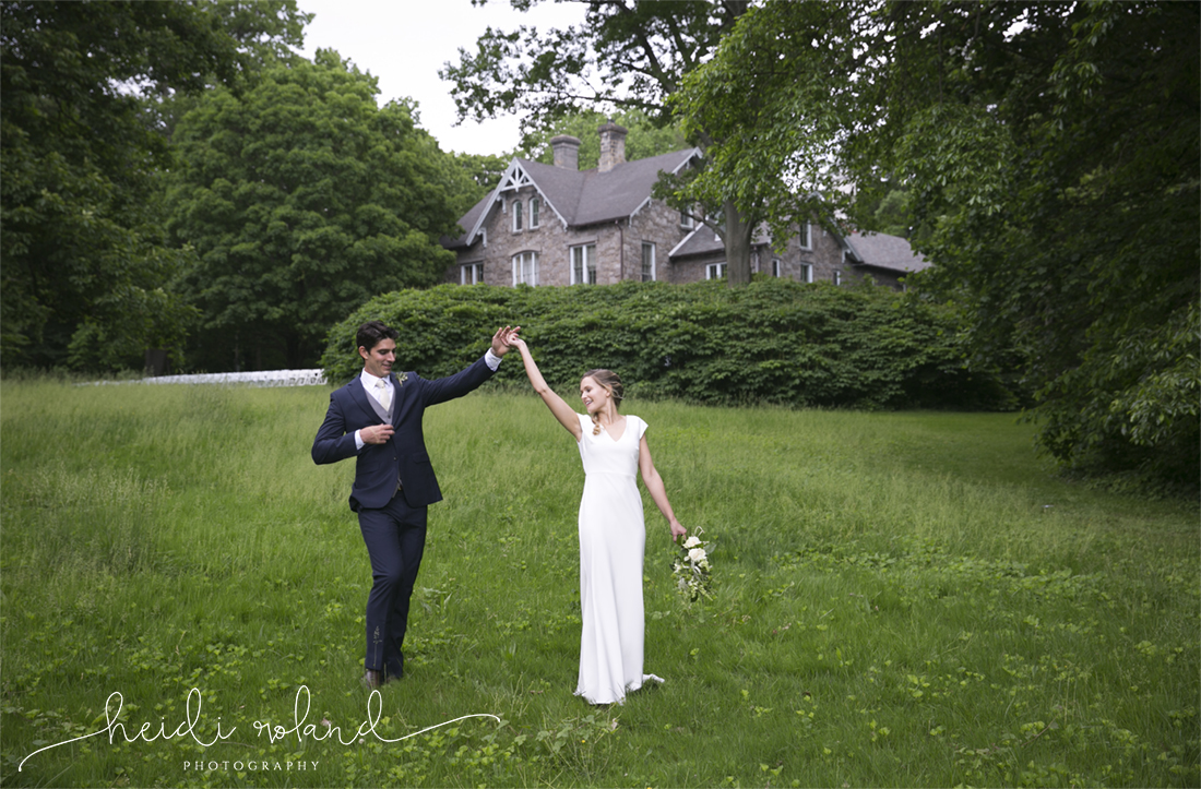 awbury arboretum wedding, bride and groom dancing in field
