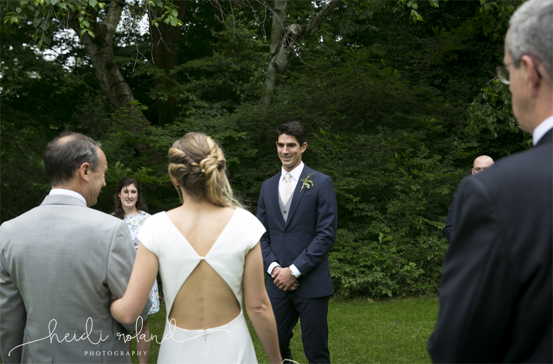 awbury arboretum wedding, groom sees bride coming down the isle