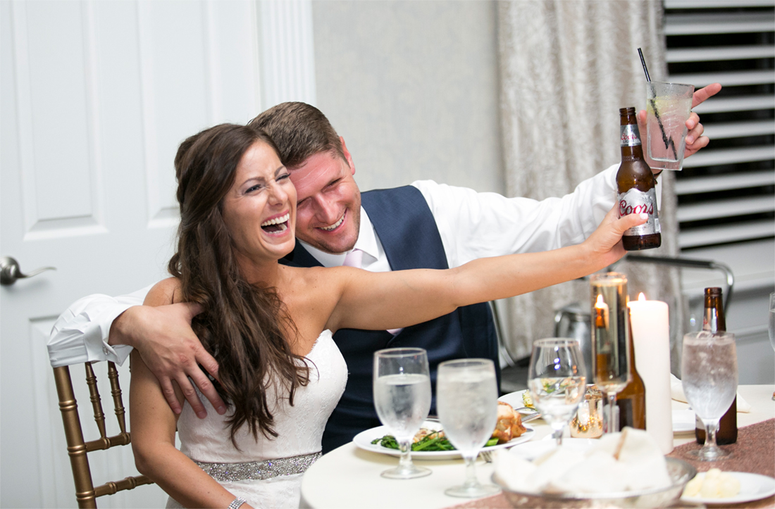 bride and groom raise a glass to cheers Blue Bell Country Club wedding