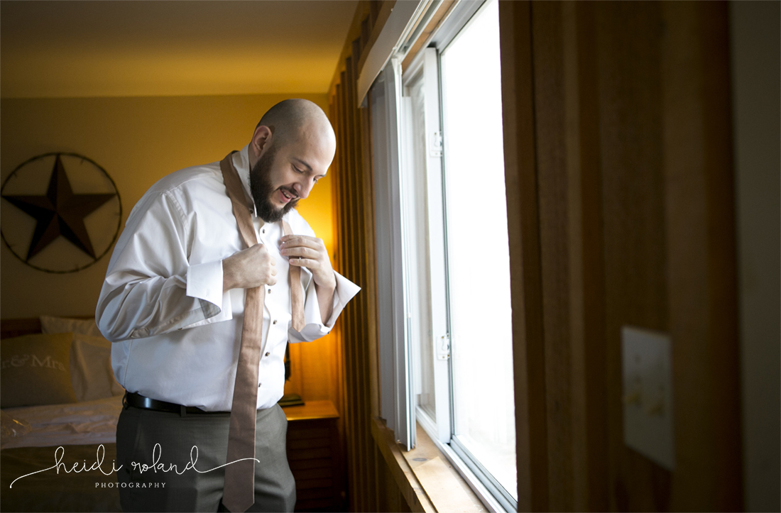 Heidi Roland Photography, Rustic Fall Wedding, groom putting on his tie in cabin