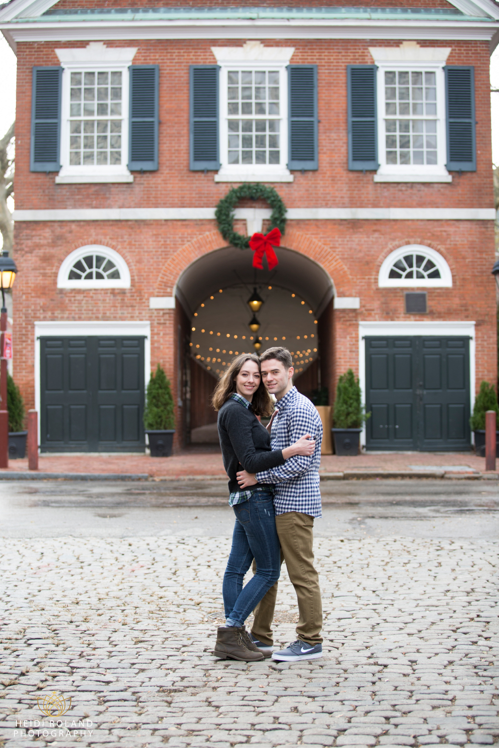 Holiday Engagement session Headhouse square with string lights and wreath
