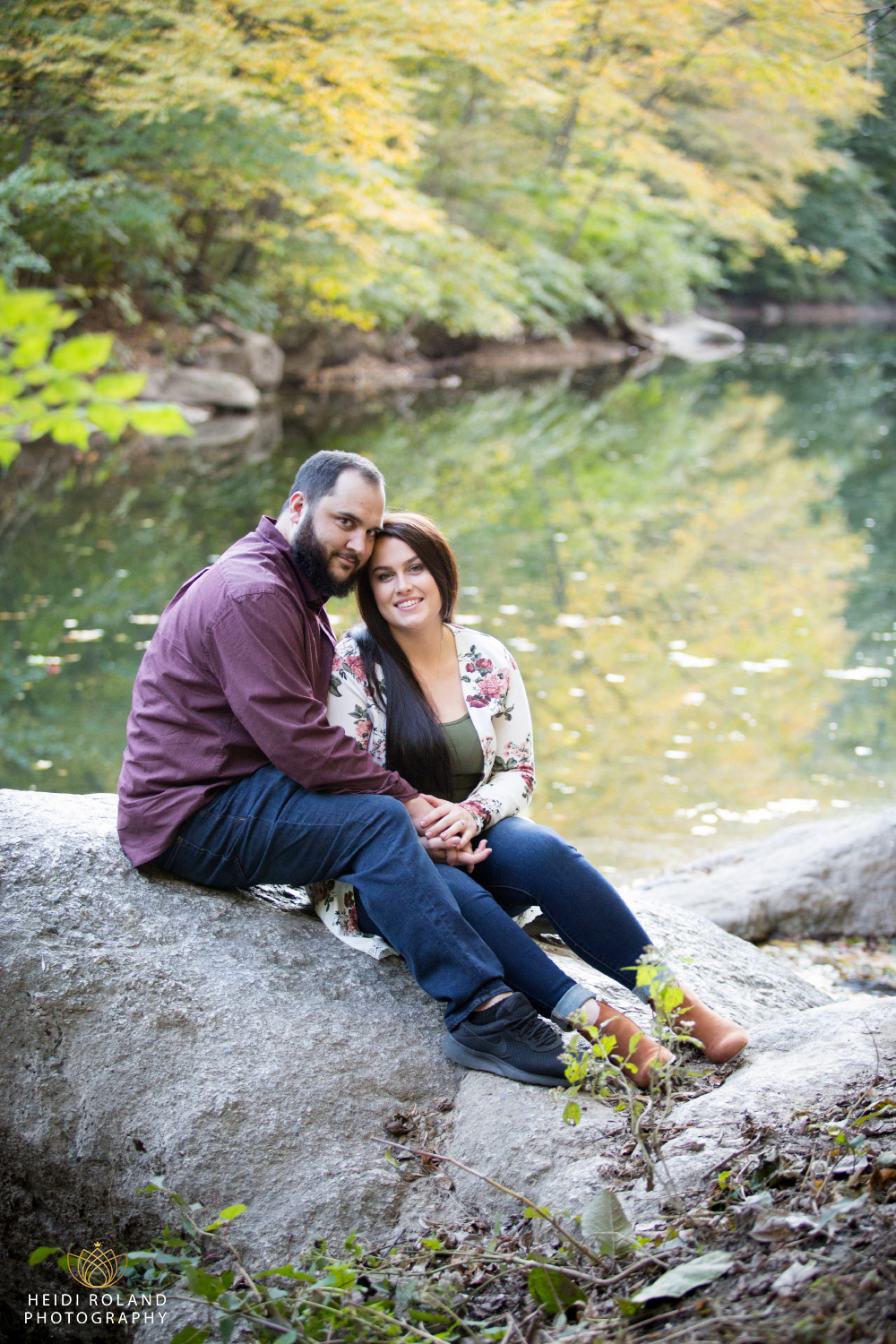 couple sitting by wissahickon creek Philadelphia engagement session