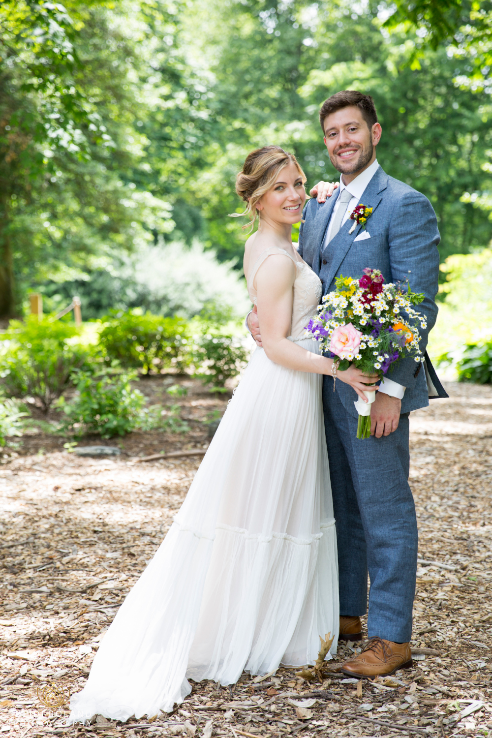 boho bride and groom in blue suit Awbury Arboretum