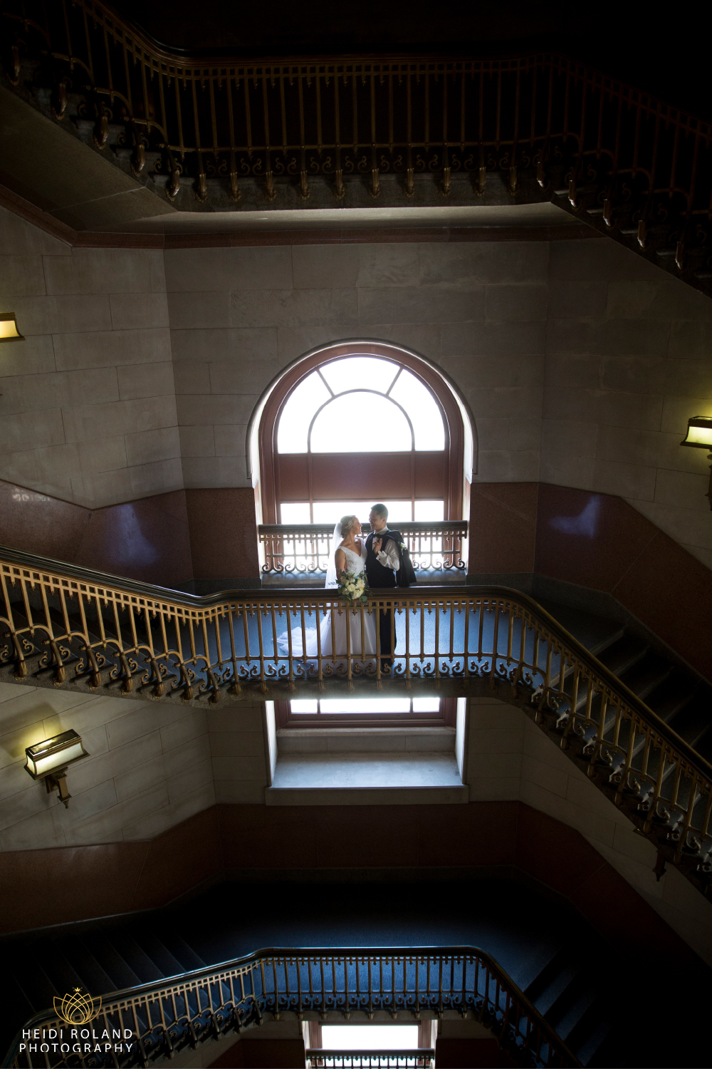 bride and groom on grand staircase