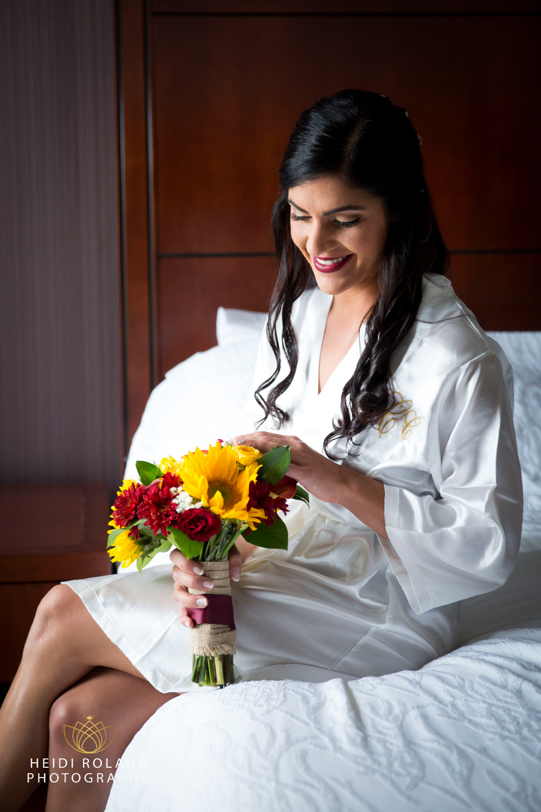 bride in robe with fall wedding bouquet