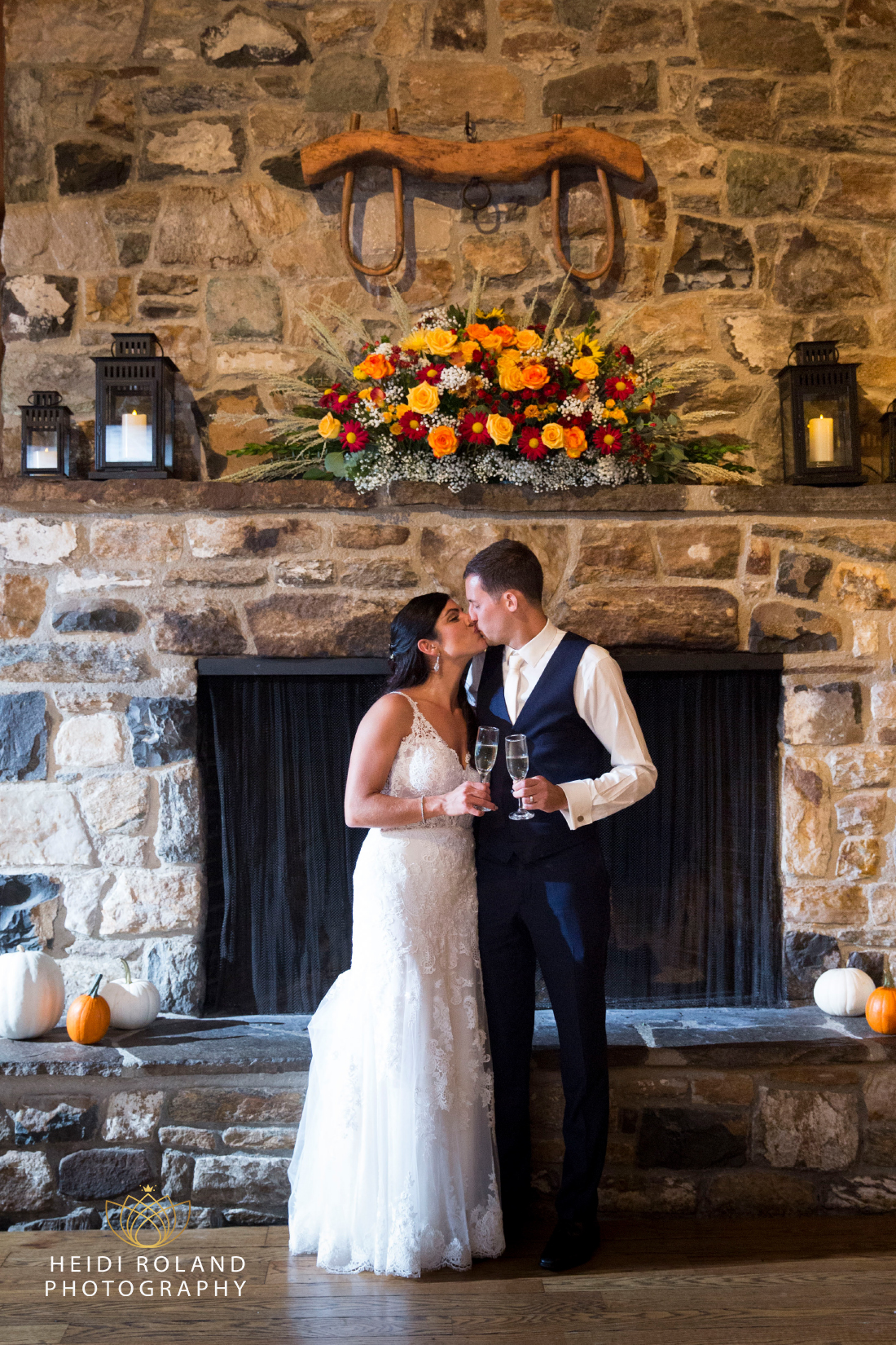 The Stone Barn Wedding Bride and Groom in front of Fireplace