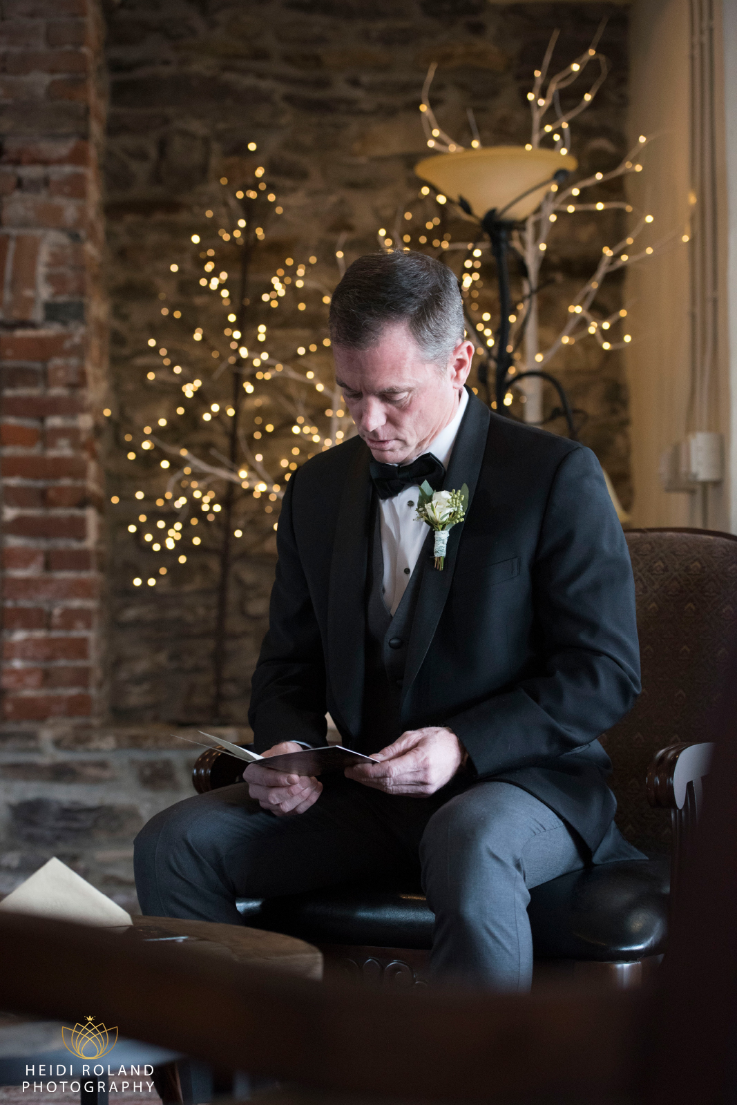 Groom reading card during getting ready