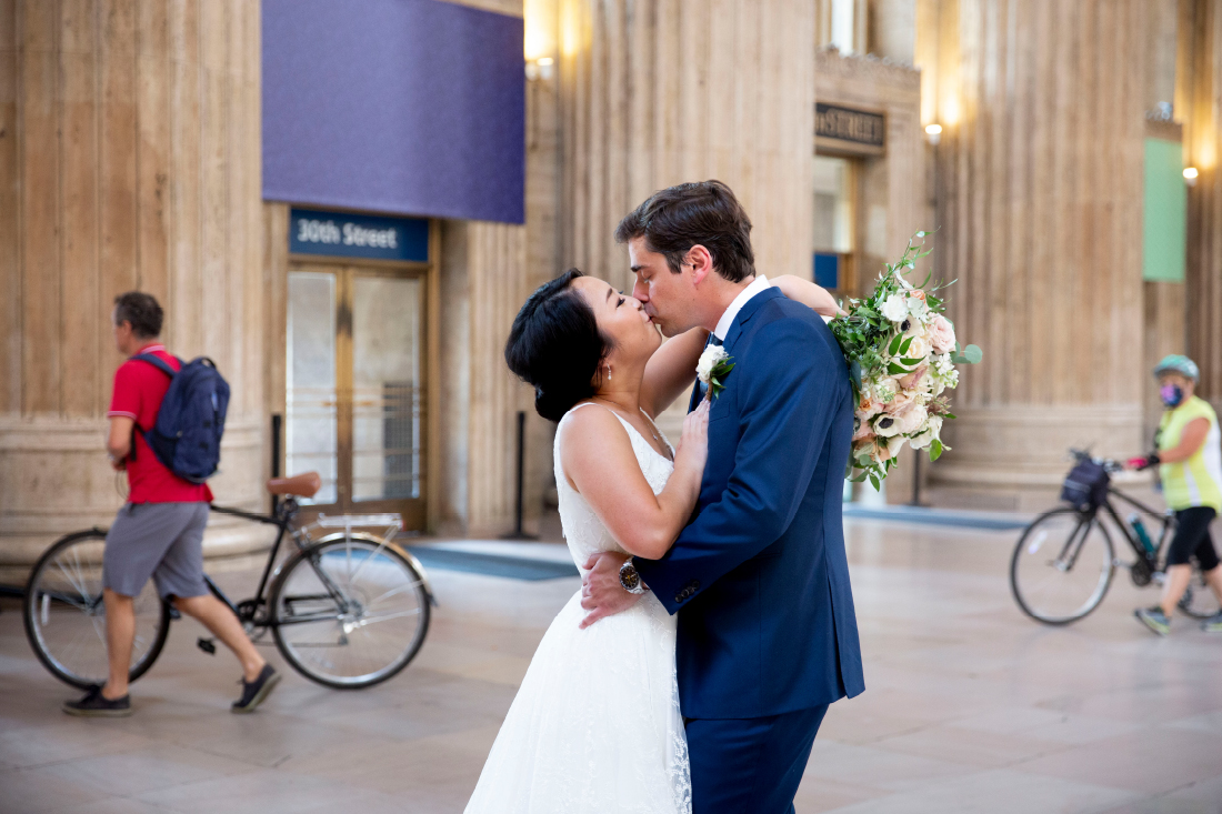 bride and groom kissing in philadelphia train station