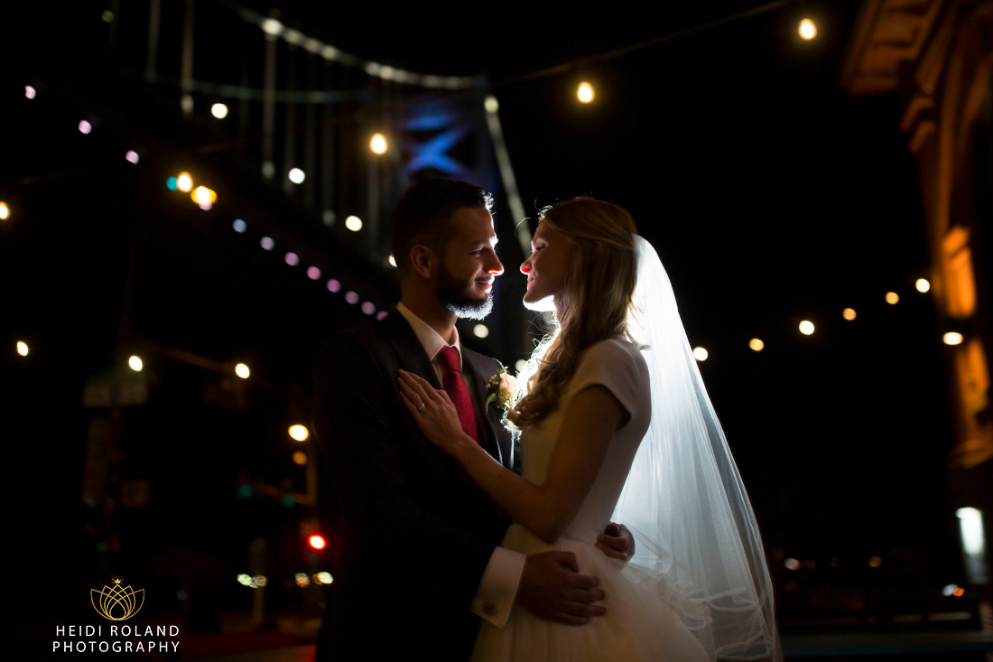 night photo of bride and groom with Benjamin Franklin bridge philadelphia