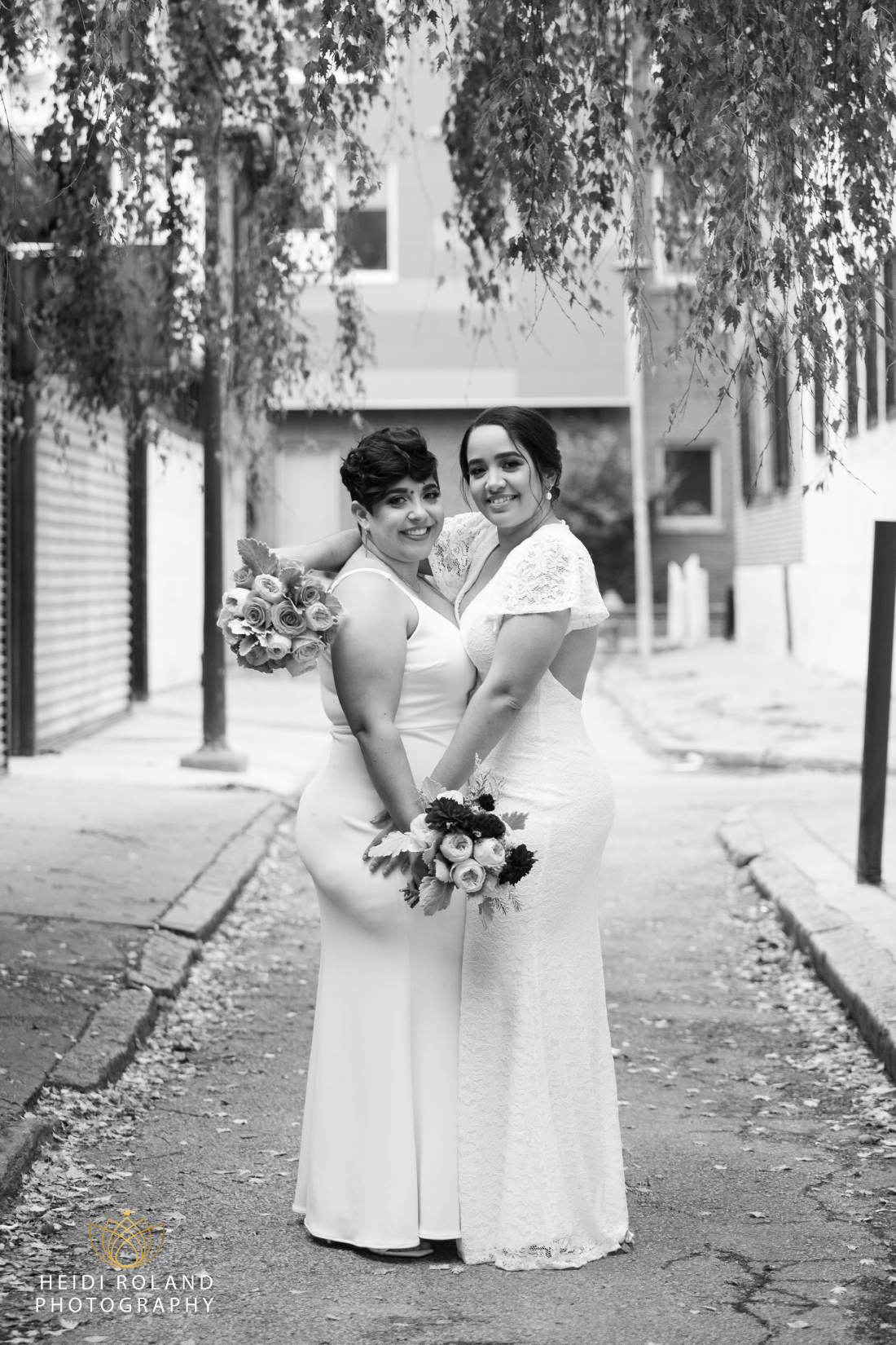 black and white photo of brides hugging in Philadelphia street