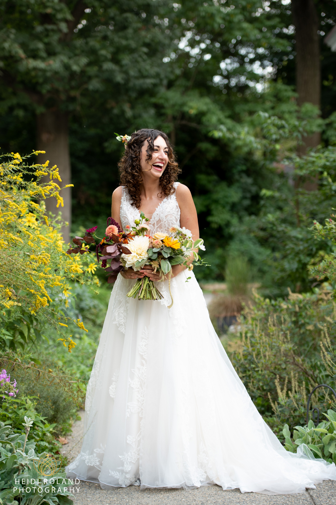 bride laughing with yellow flowers at Portico Awbury Arboretum Wedding