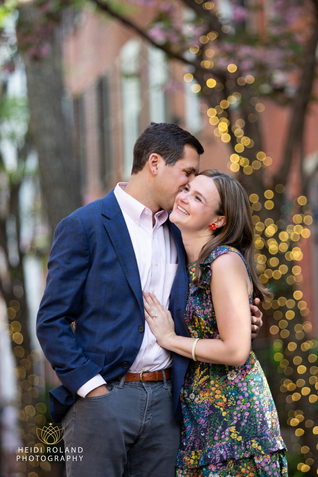 Man whispering in smiling woman's ear after philadelphia proposal 