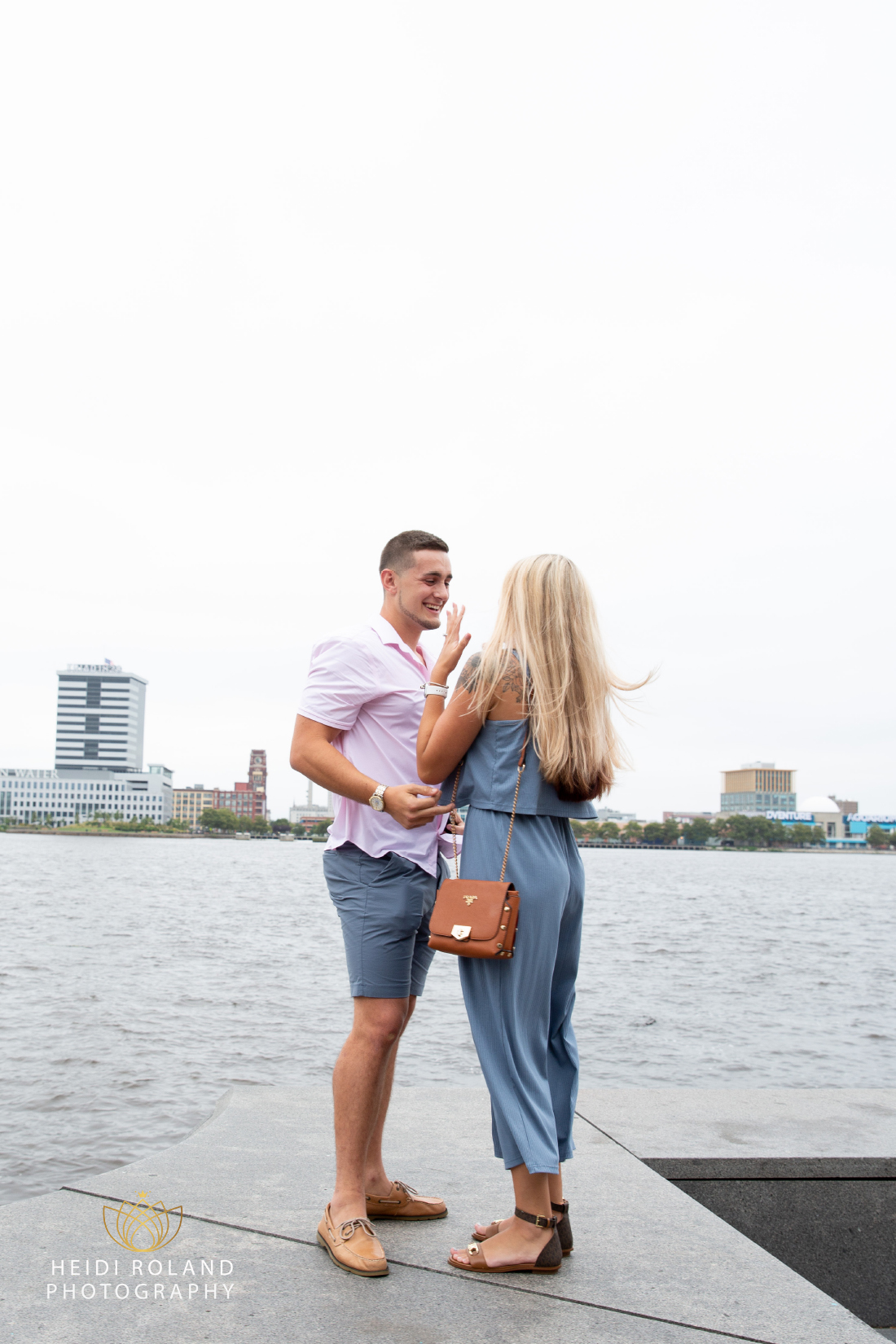 Newly engaged happy couple celebrating after proposal near the Delaware River in Philly