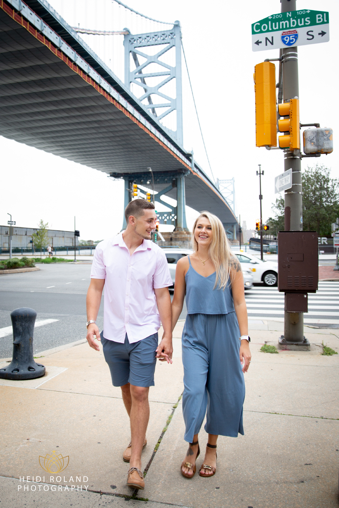 Philadelphia couple walking down the street after proposal near Ben Franklin Bridge