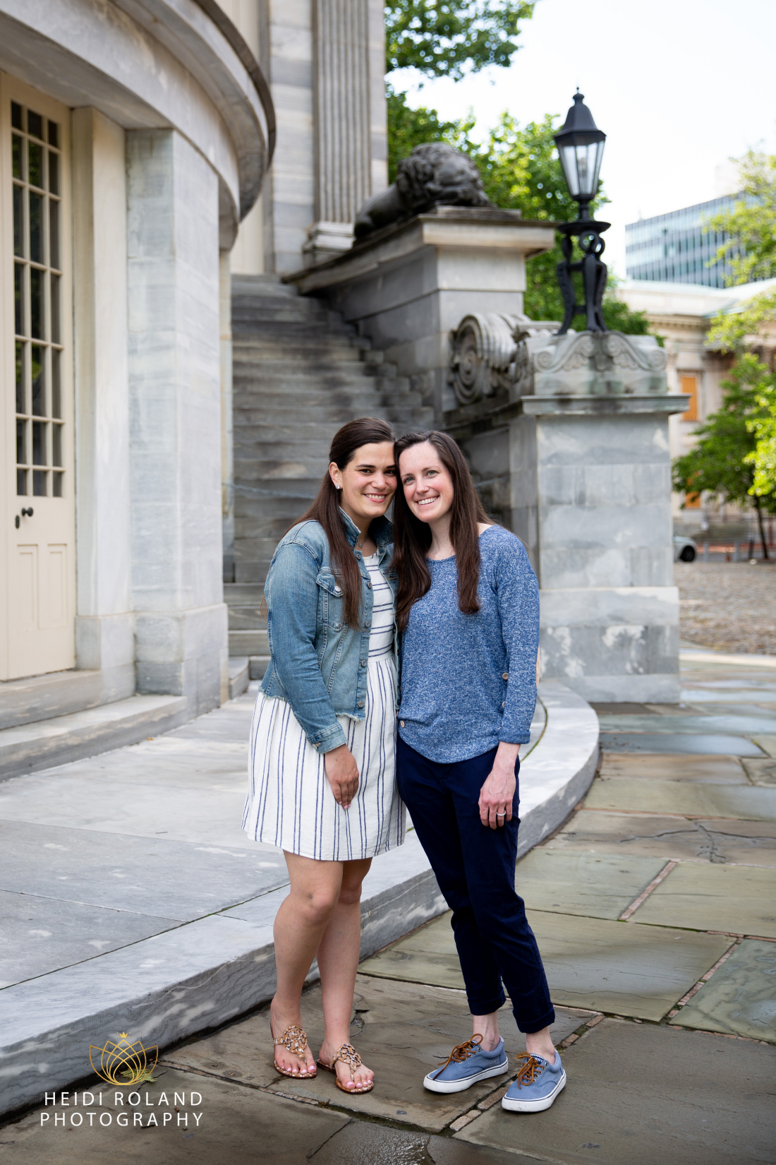 Engaged women smiling outside of Merchant Exchange Building in Old City Philly