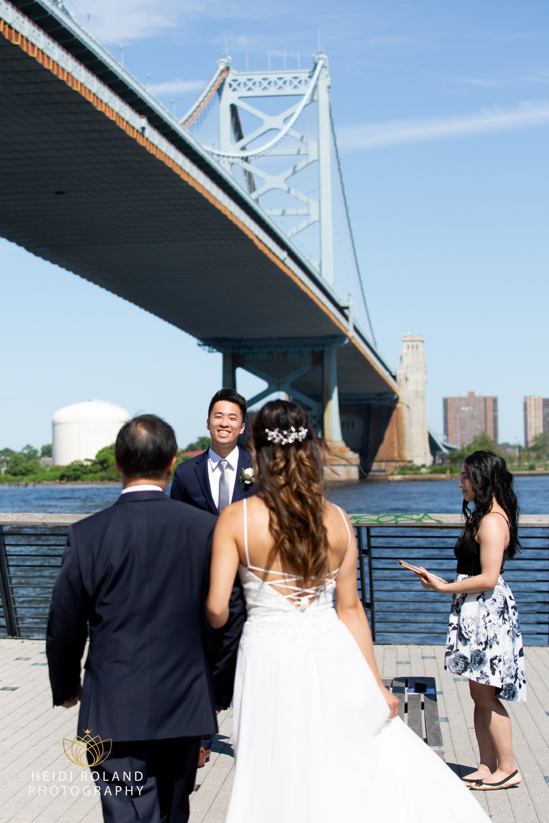 Groom smiling at bride and her father at Race Street Pier in Philly