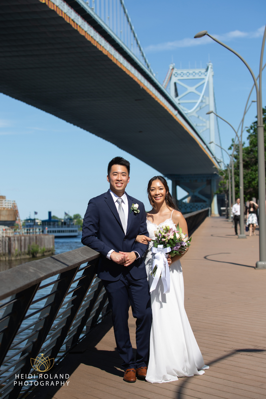 Bride and Groom on Race Street Pier in Philadelphia with Ben Franklin Bridge in the background