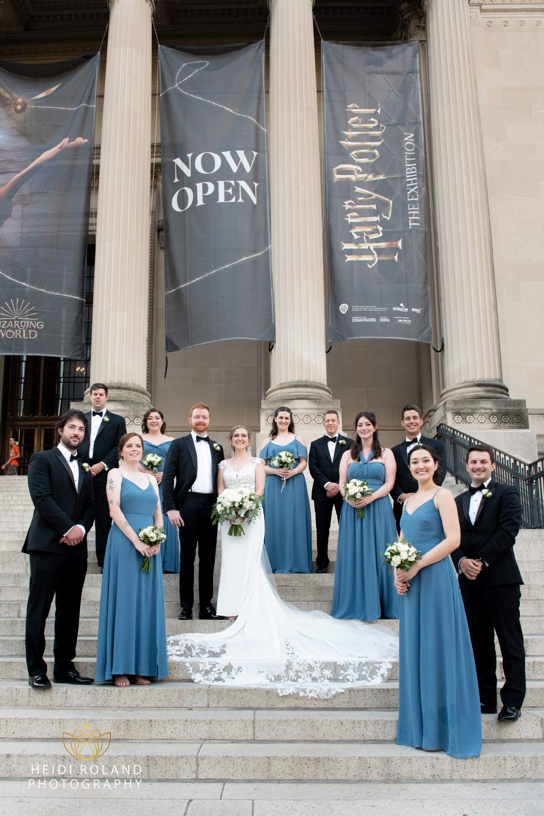 Couple with bridal party outside the Franklin Institute in Philly