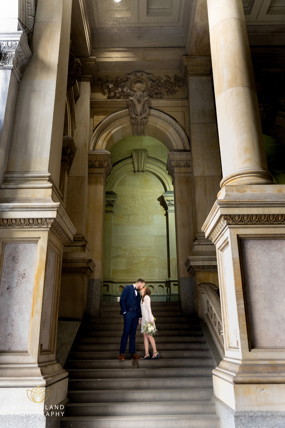 wedding day photos of couple in Philadelphia City Hall Arch