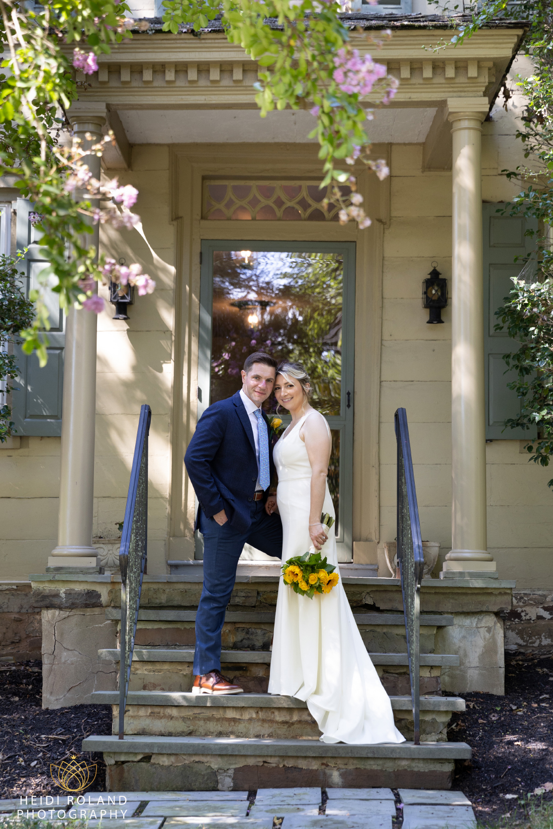 bride and groom on steps with flowers at The Inn at Glencairn Wedding Princeton NJ