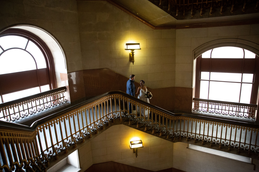 wedding couple walking down the staircase inside Philadelphia City Hall