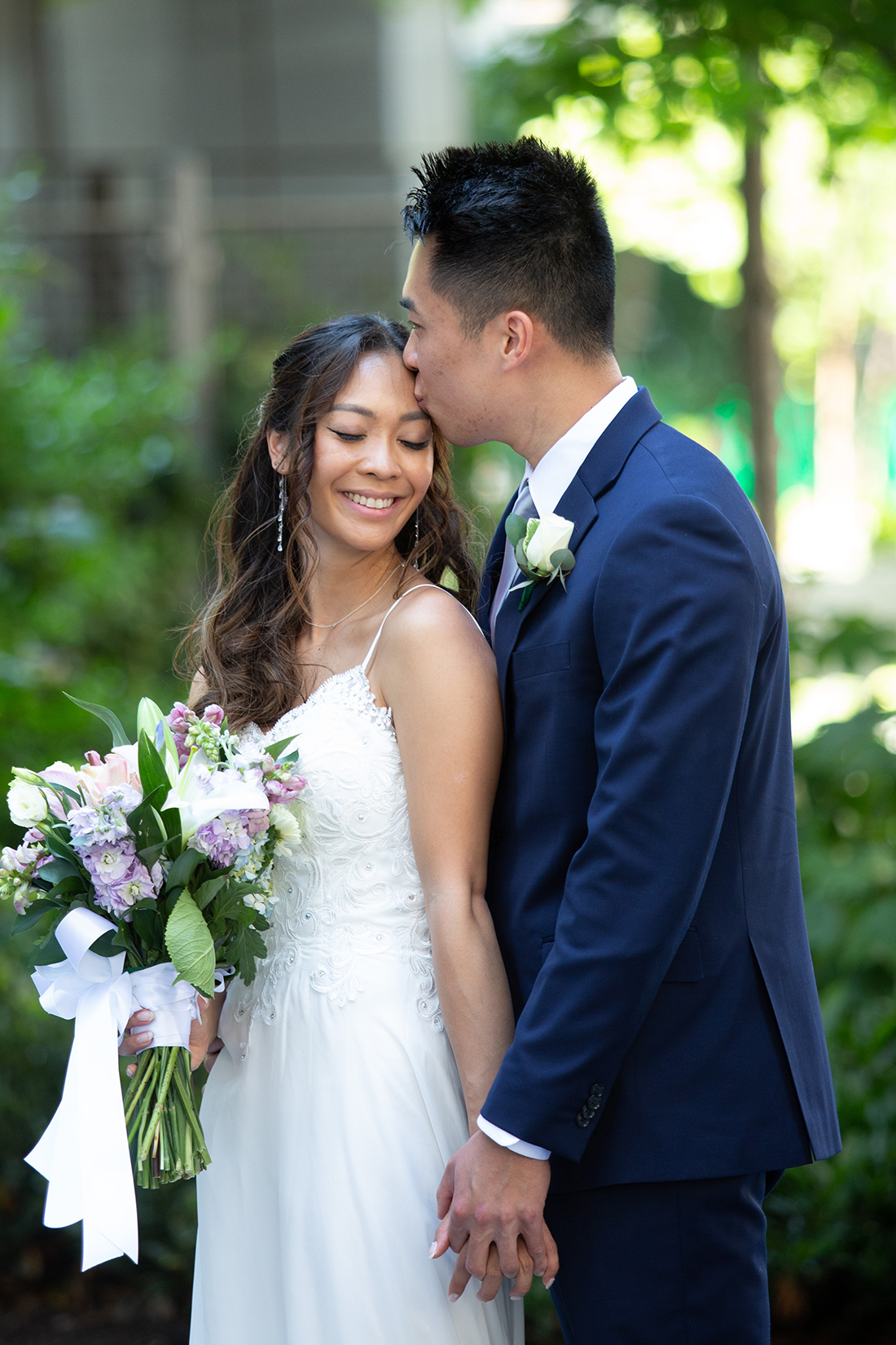 groom kissing bride near Philadelphia City Hall
