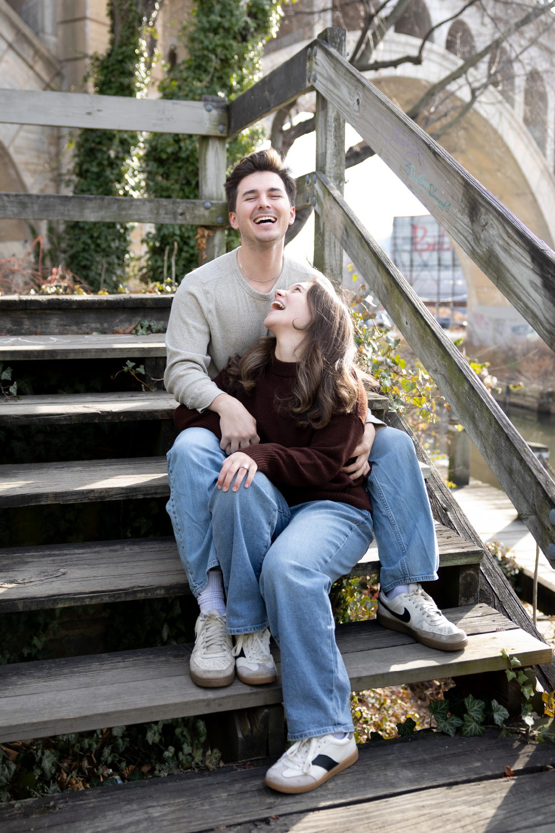 couples laughs together in their engagement session in Philadelphia