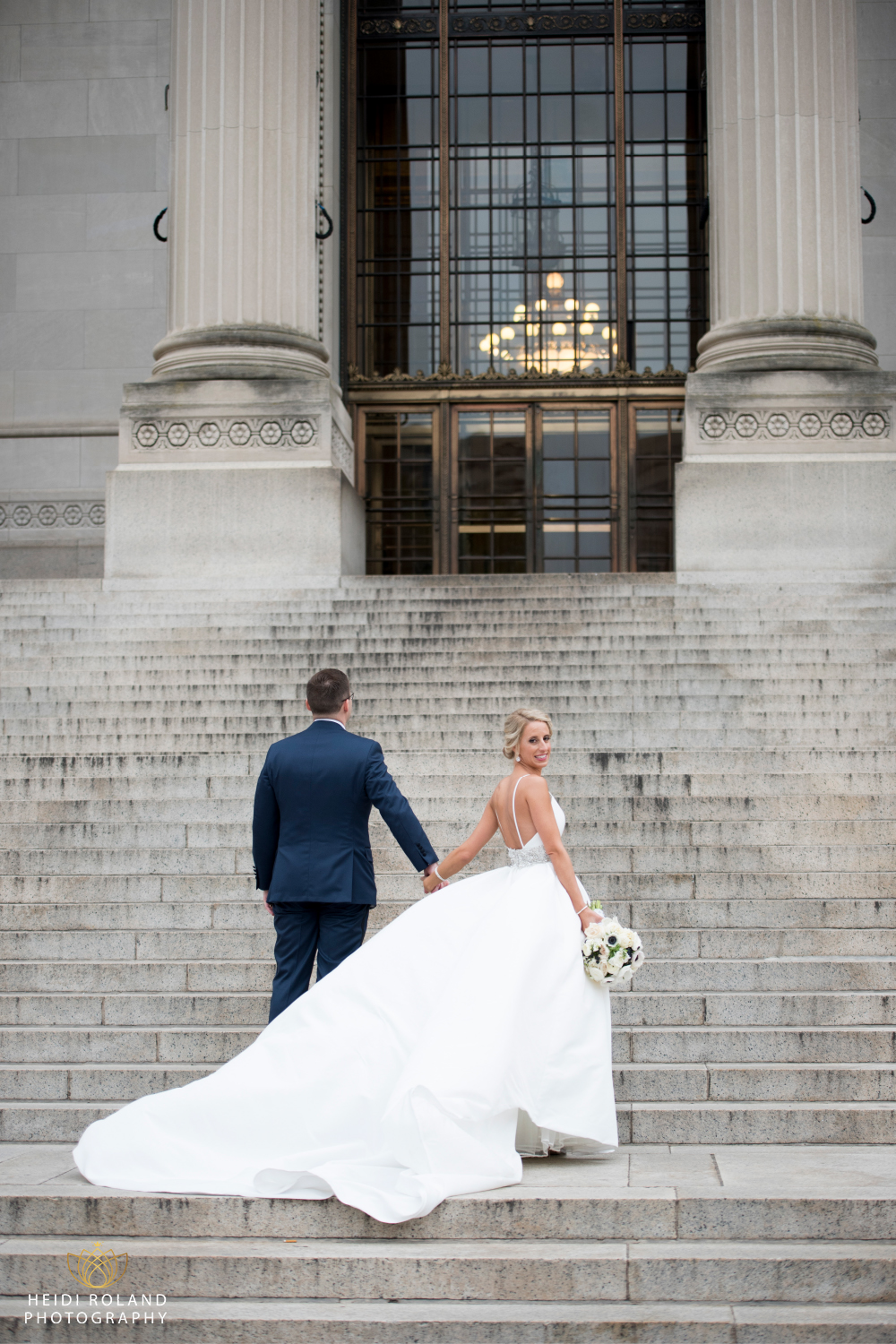 bride and groom on the steps of the at The Franklin Institute museum Philadelphia PA