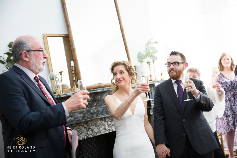 wedding couple toasting with champagne vaux studio 