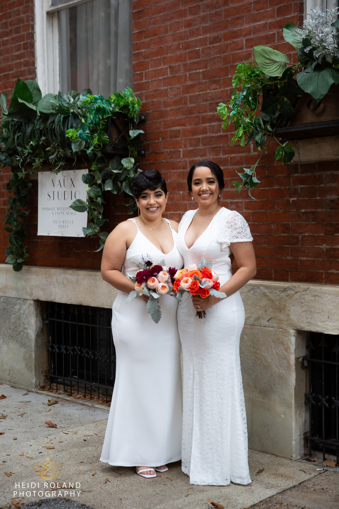 bride and bride outside on sidewalk in front of Vaux Studio Philly