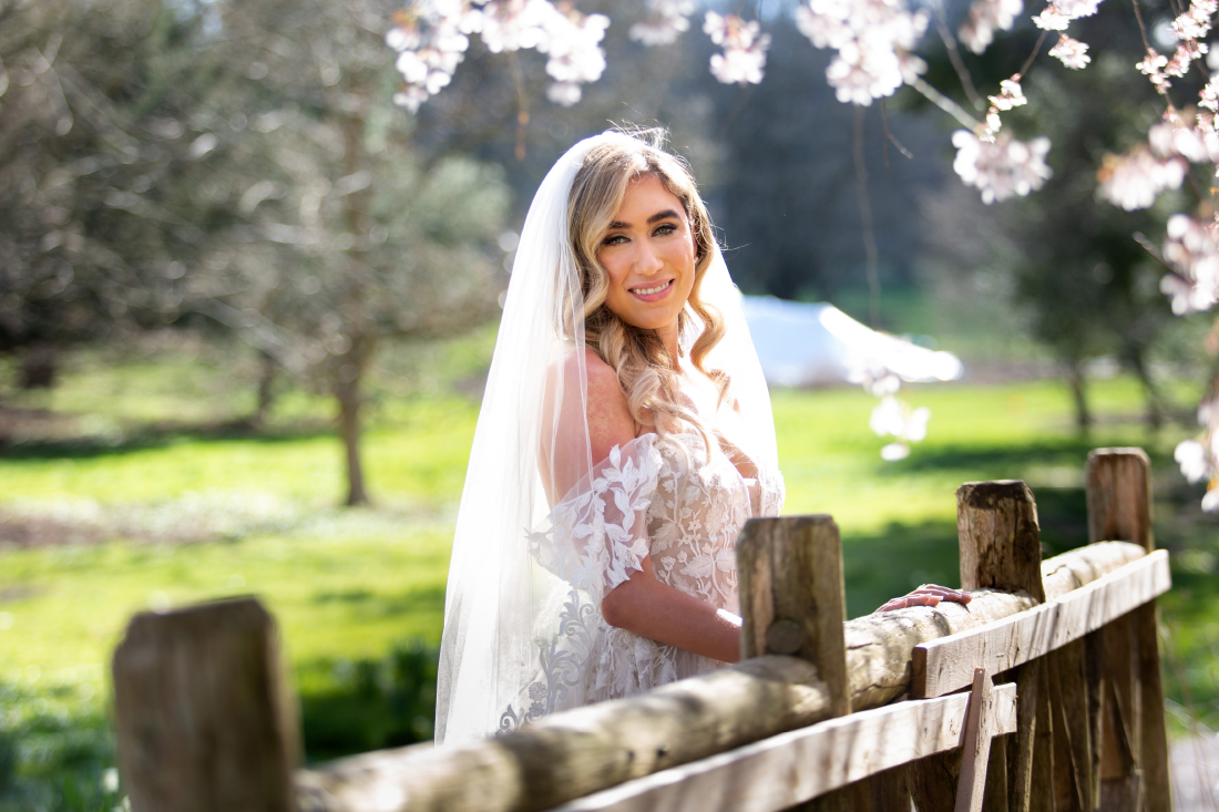 photo of bride outside near wooden fence