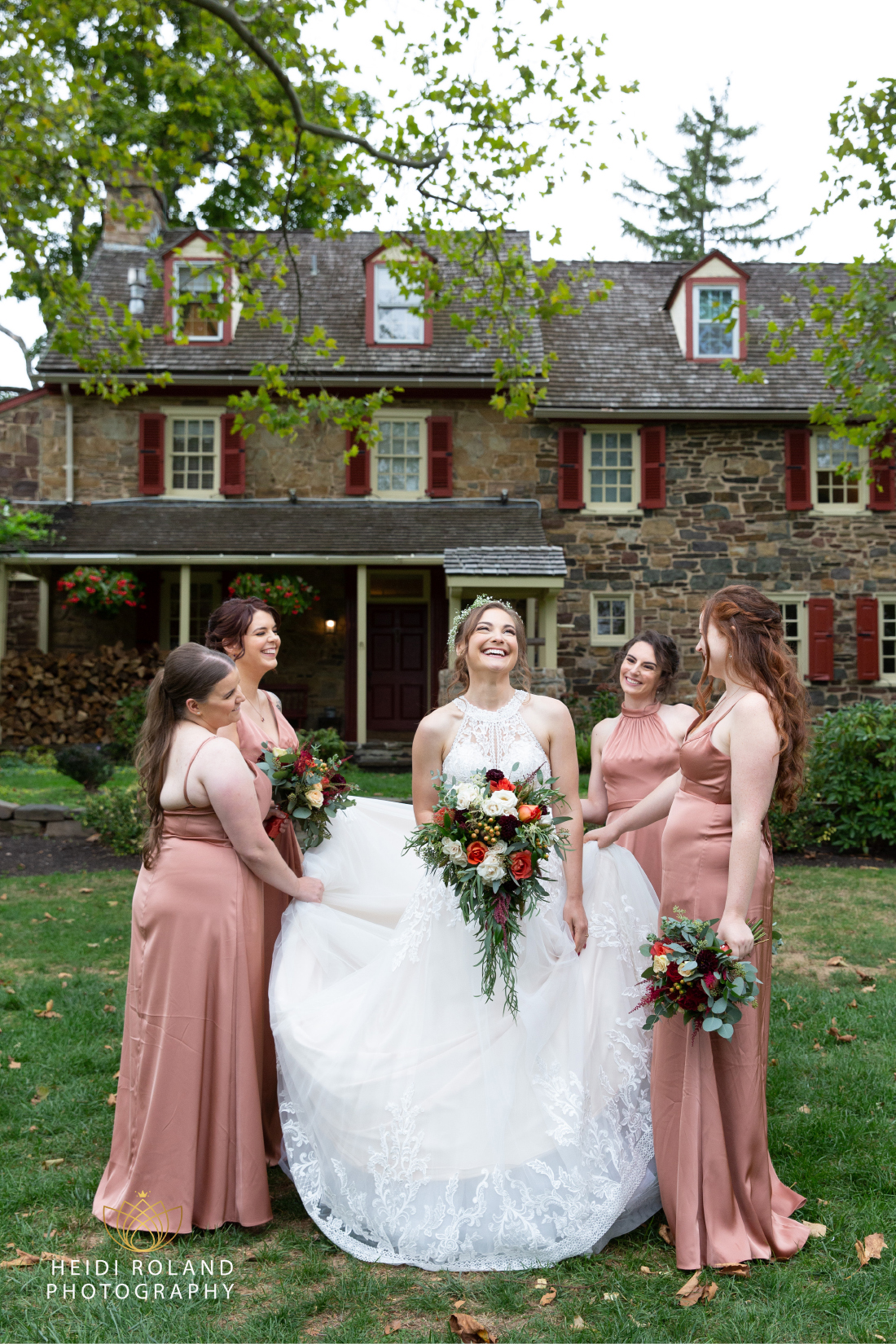 Bride with bridesmaids outside of the stone Joseph Ambler Inn in Wayne Pennsylvania