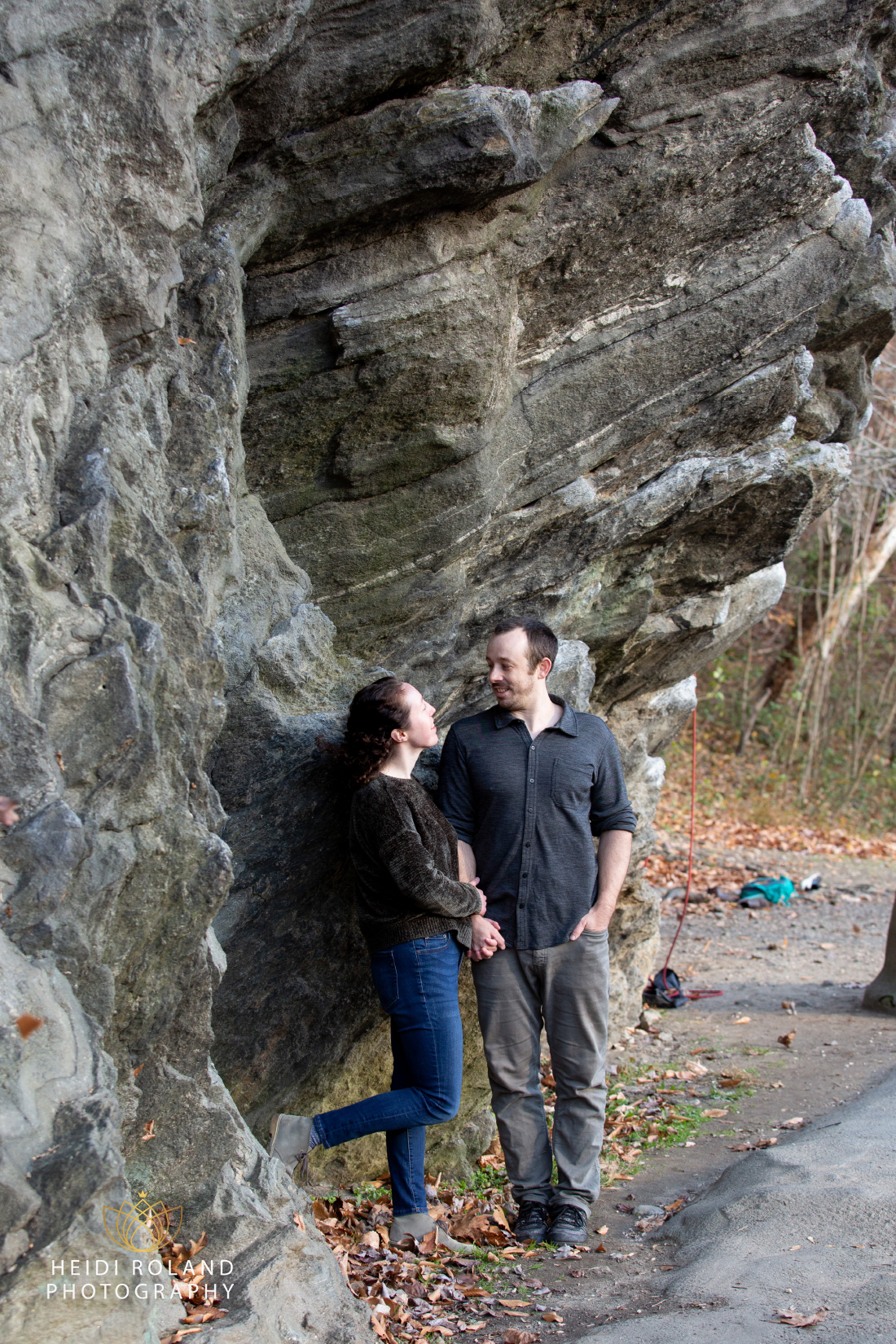 Engaged couple in front of rock in philadelphia