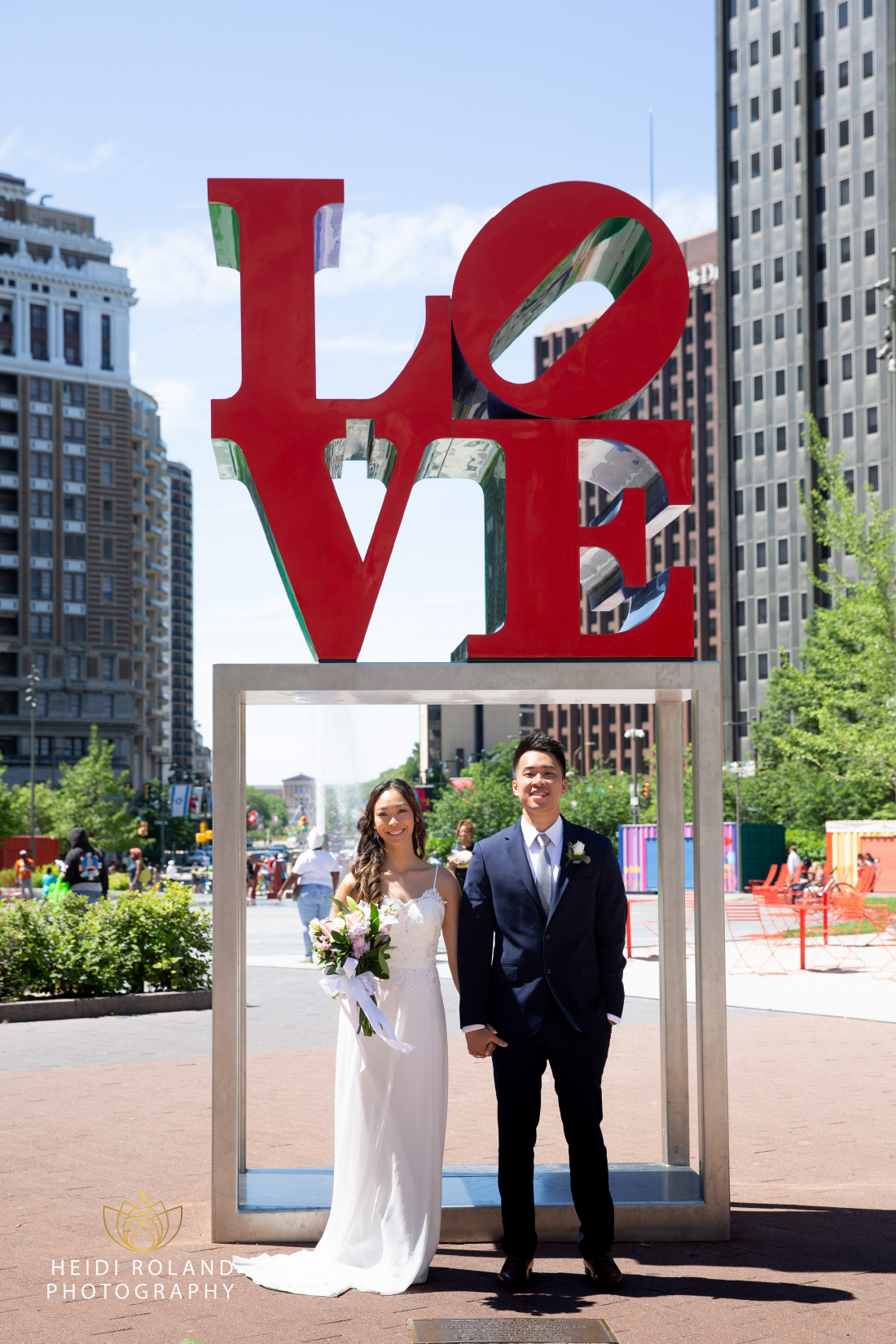 Couple standing in front of Philadelphia LOVE Park sign in Center City 