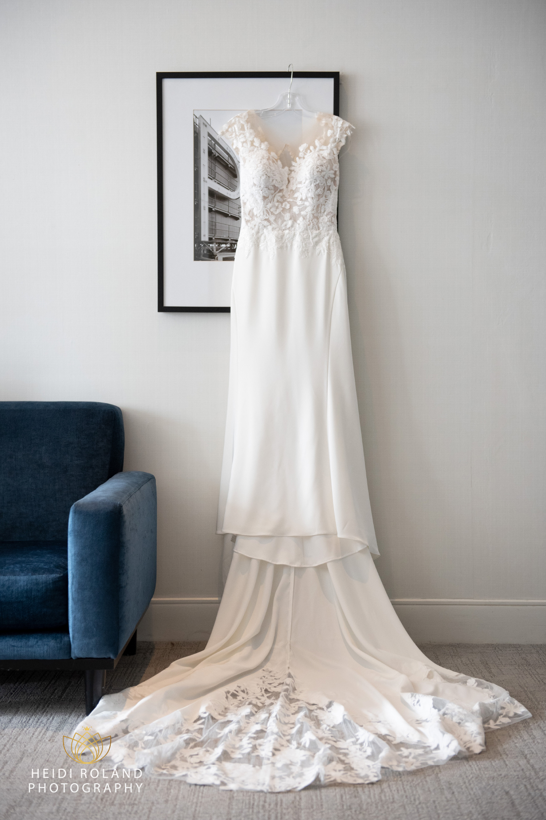 Lacy white wedding dress hanging from a picture frame at Philadelphia wedding