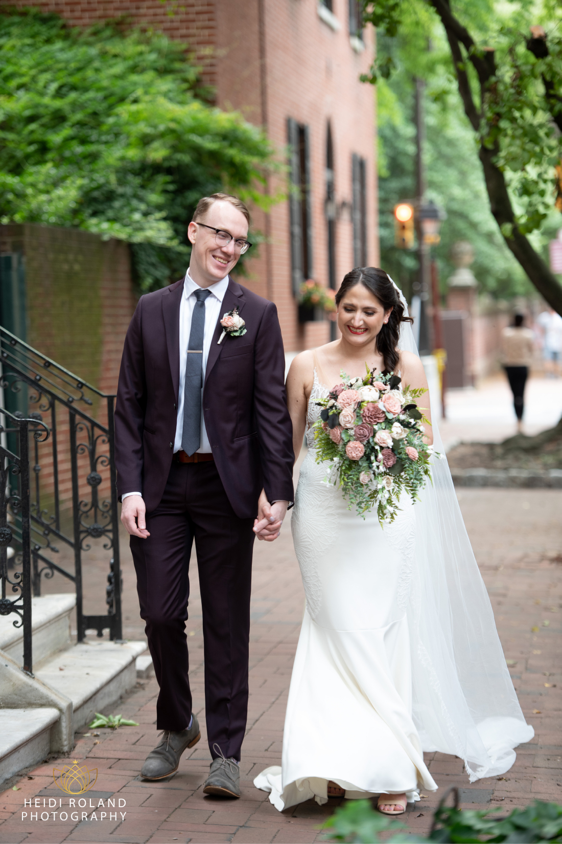 bride and groom walking down the city street in Philadelphia