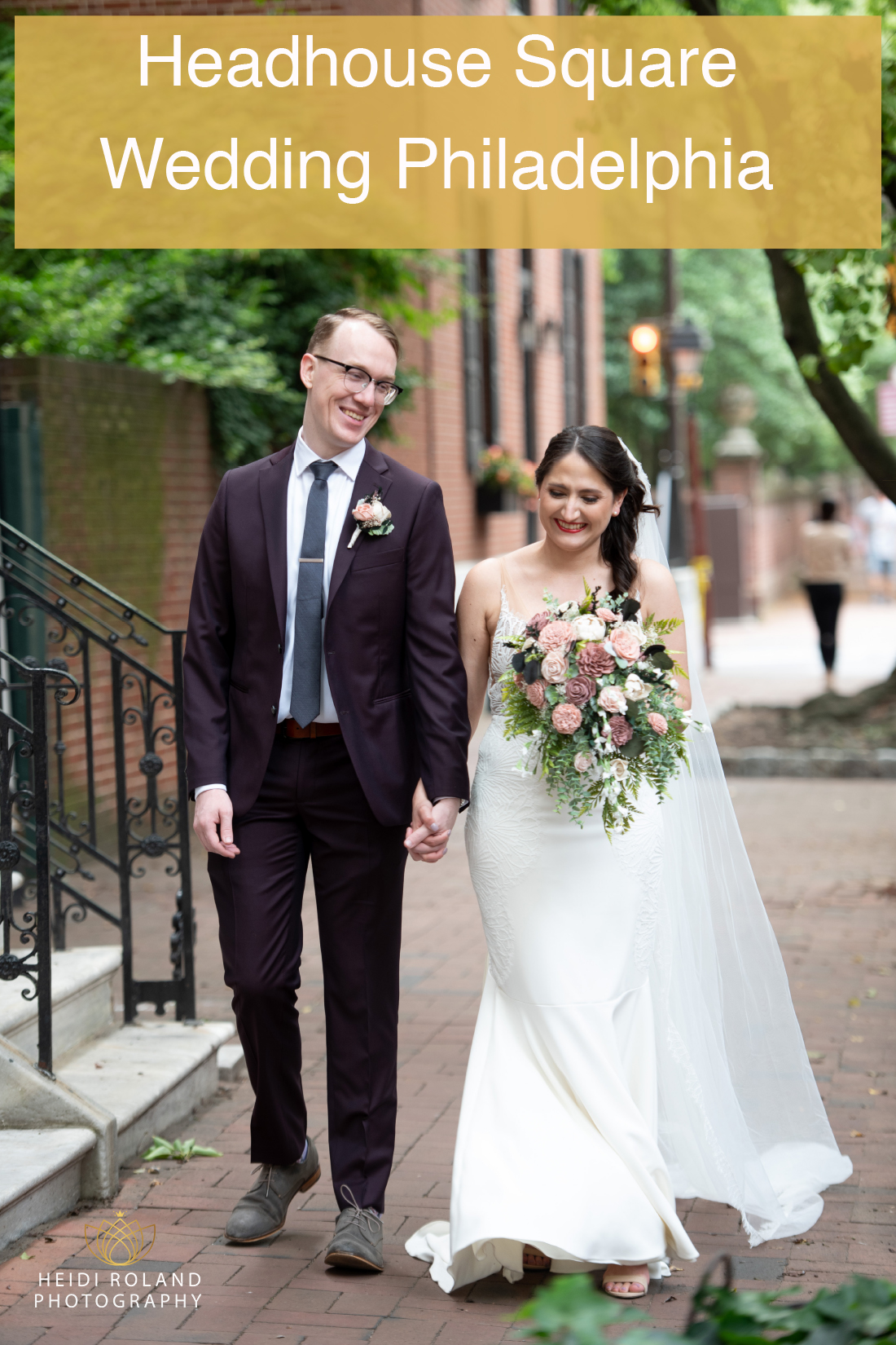 bride and groom smiling on their wedding day walking on the sidewalk Philadelphia PA