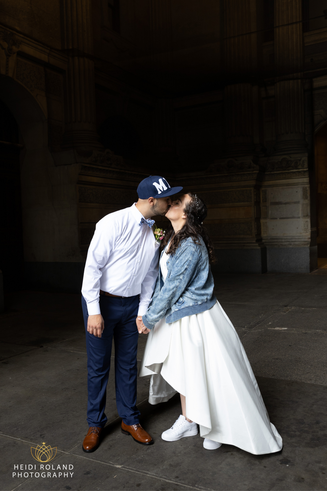 Bride and groom kissing with custom jean jacket